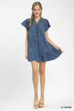 Woman wearing a light denim dress on a white background
