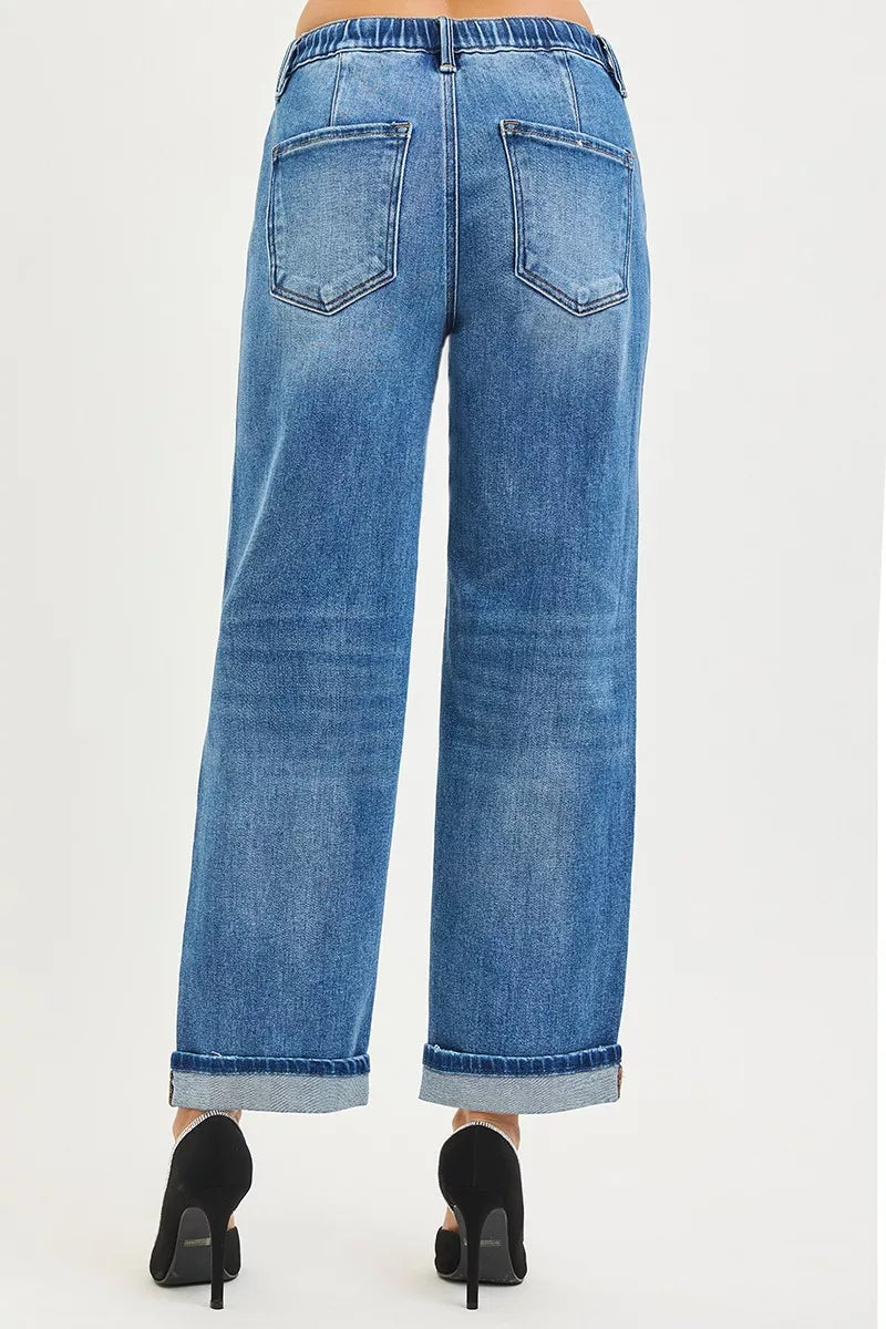 Lady showing the back of Blue jeans with a white background