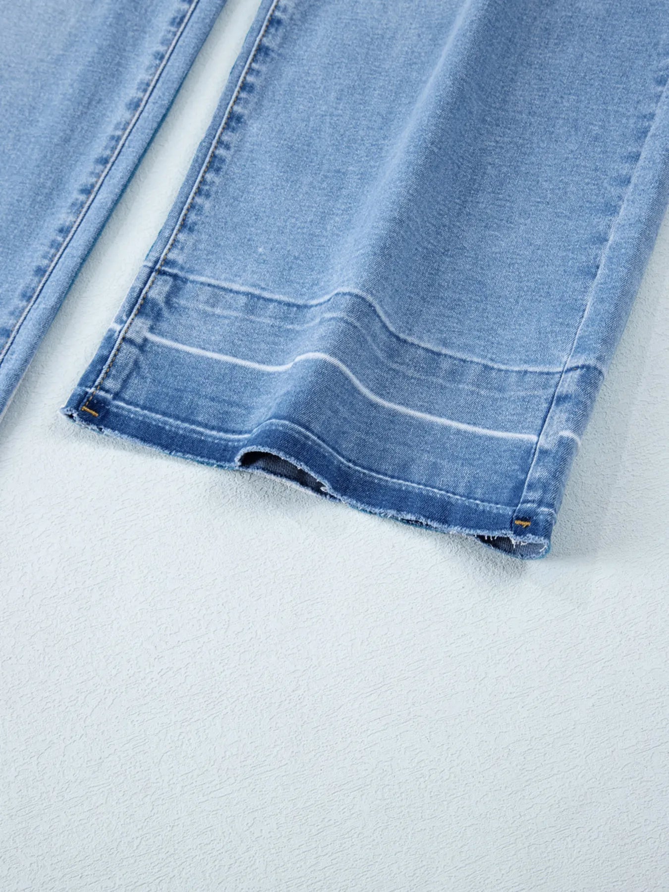 Close-up of blue denim fabric on a white background