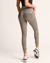 Gray leggings with a heart detail on a plain background
