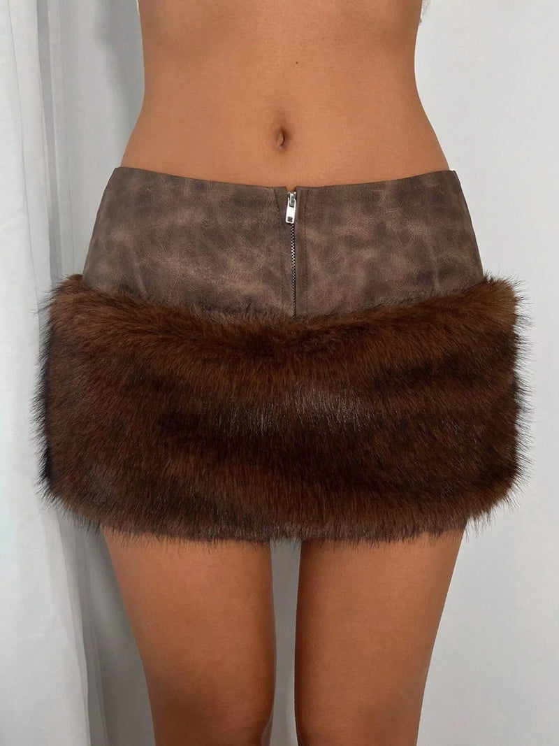 A brown faux fur and leopard-print mini skirt with a front zipper, shown on a model from the waist down against a white curtain background.