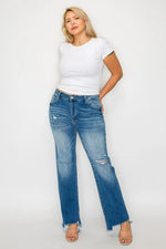 Woman wearing a white t-shirt and blue jeans on a white background