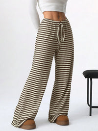Striped pants worn by a person on a white background