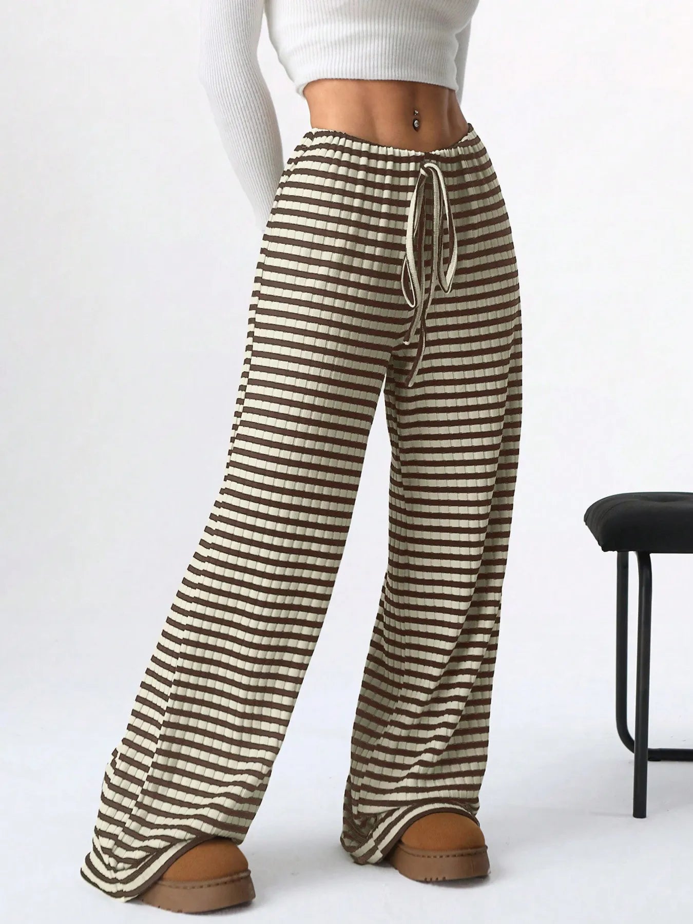 Striped pants worn by a person on a white background