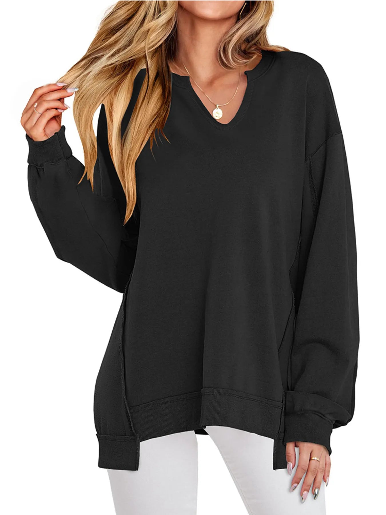 Black oversized sweatshirt worn by a person on a white background
