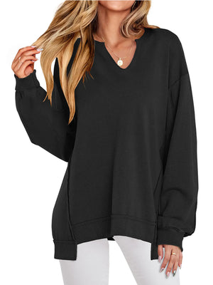 Black oversized sweatshirt worn by a person on a white background