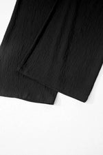 Close-up of a black fabric piece on a white background