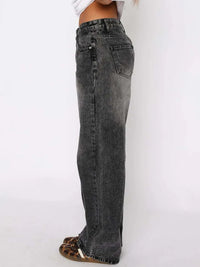 Black jeans worn by a person on a white background