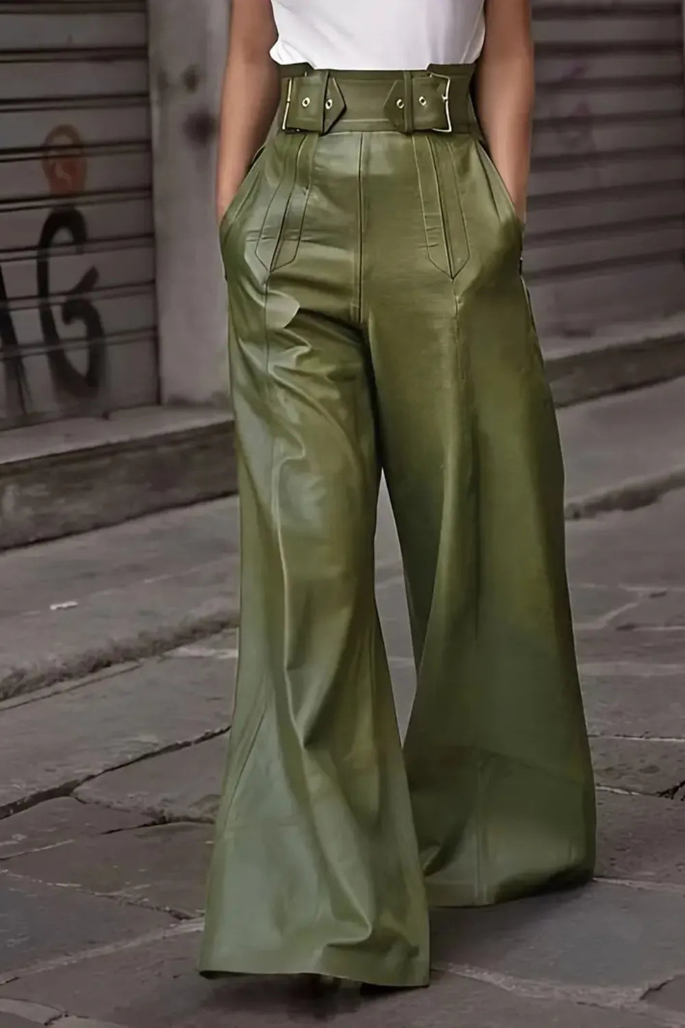 Person wearing green wide-leg pants on a street background