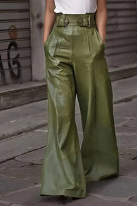 Person wearing green wide-leg pants on a street background