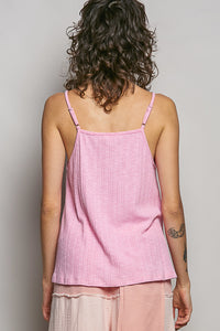 Person wearing a pink tank top against a plain background
