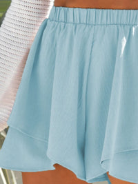 Light blue skirt worn by a person with a blurred background