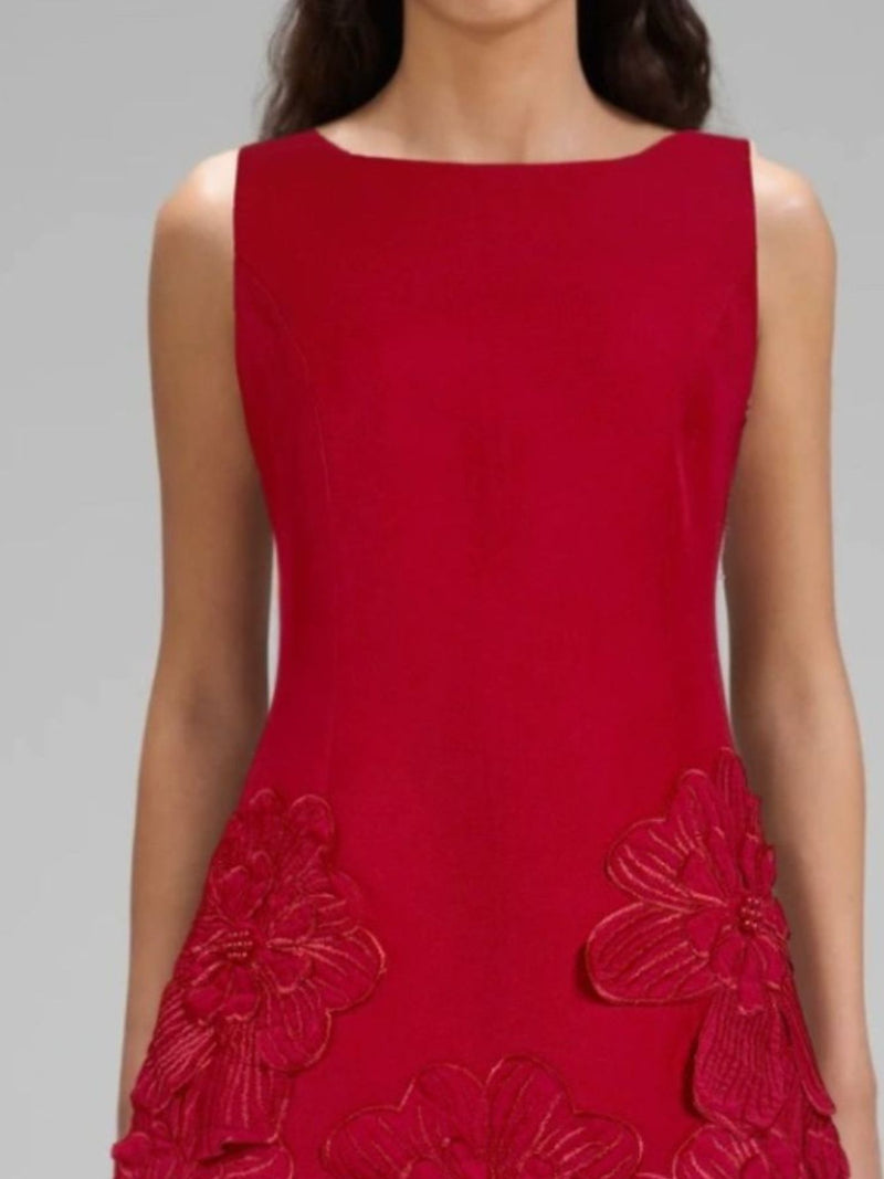 Red dress with floral embellishments on a gray background