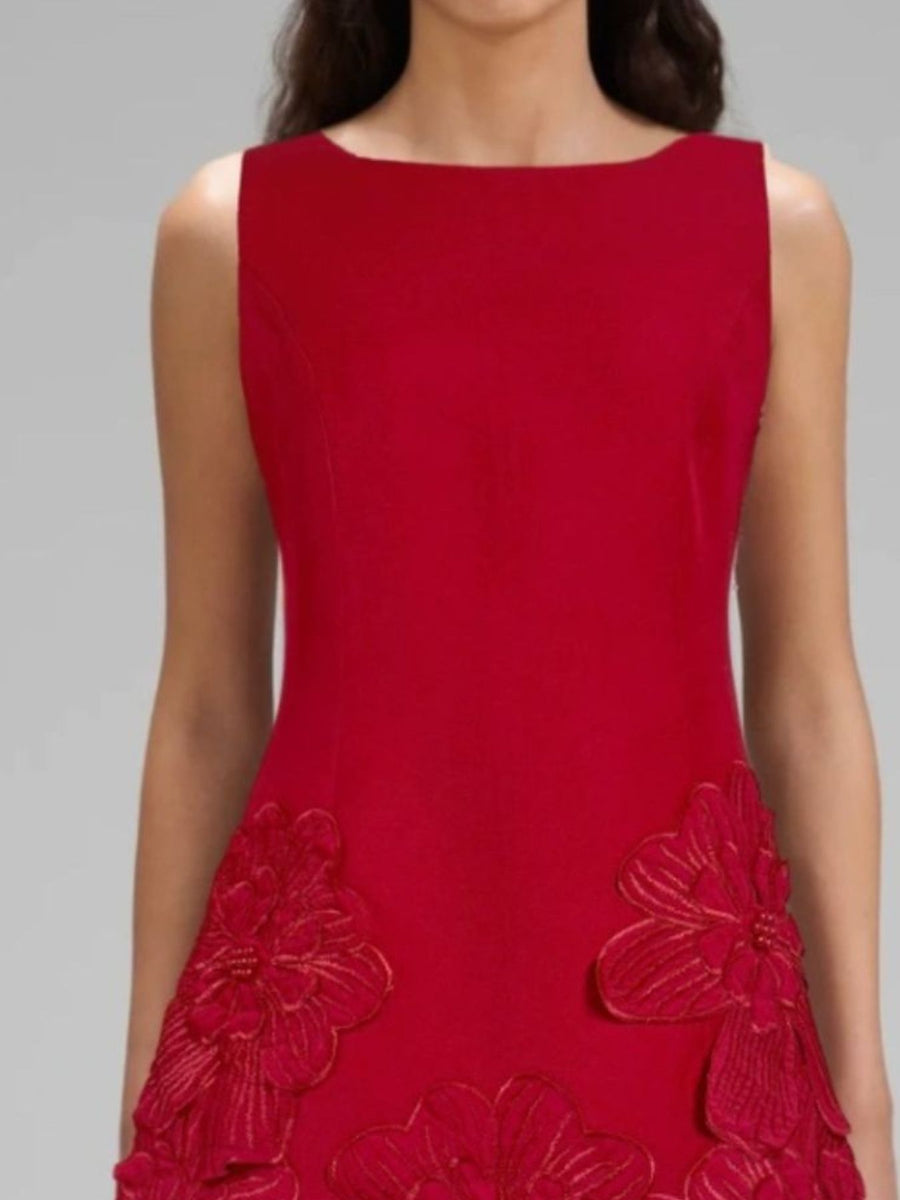 Red dress with floral embellishments on a gray background
