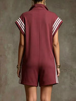 Maroon romper with white stripes on a textured gray background
