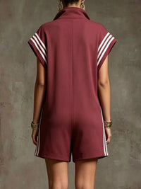 Maroon romper with white stripes on a textured gray background