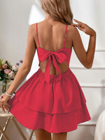 Red dress with open back worn by a person, with a neutral background