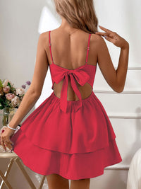 Red dress with open back worn by a person, with a neutral background