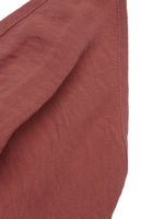 Close-up of a textured red fabric with a white background