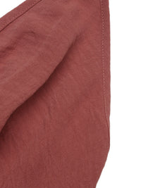 Close-up of a textured red fabric with a white background
