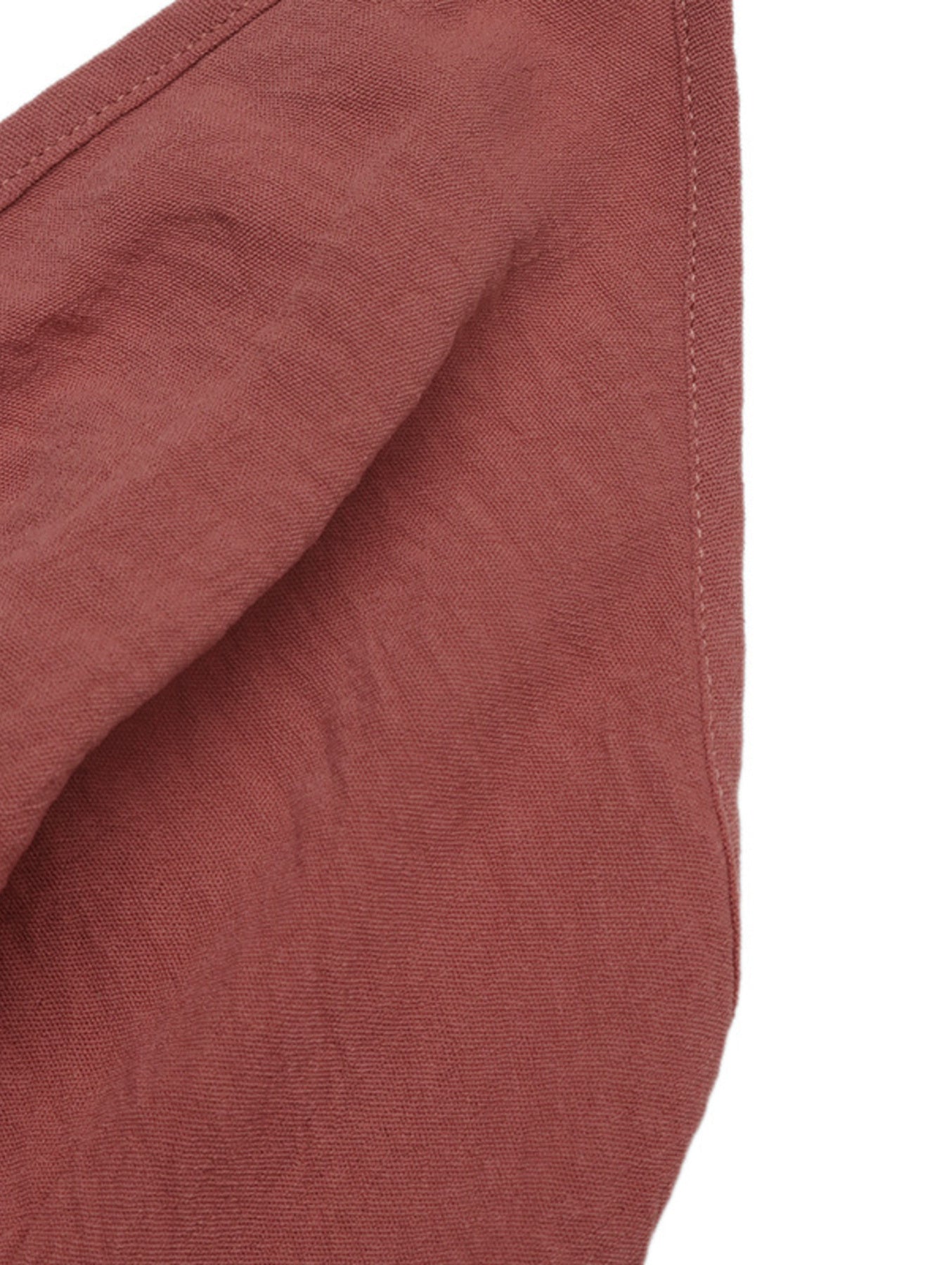 Close-up of a textured red fabric with a white background