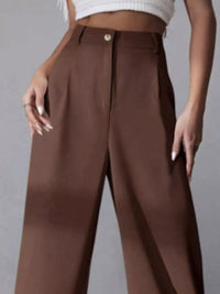 Brown wide-leg pants worn by a person on a gray background