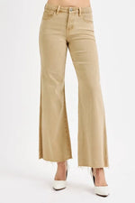Beige flared jeans on a white background