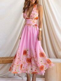 Woman wearing a pink floral dress against a white curtain background