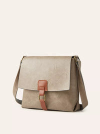 Beige leather handbag with a pink strap on a white background
