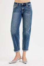 Blue jeans worn by a person on a white background