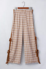 Plaid pants with brown leather straps on a white background