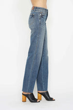 Blue jeans worn by a person on a white background