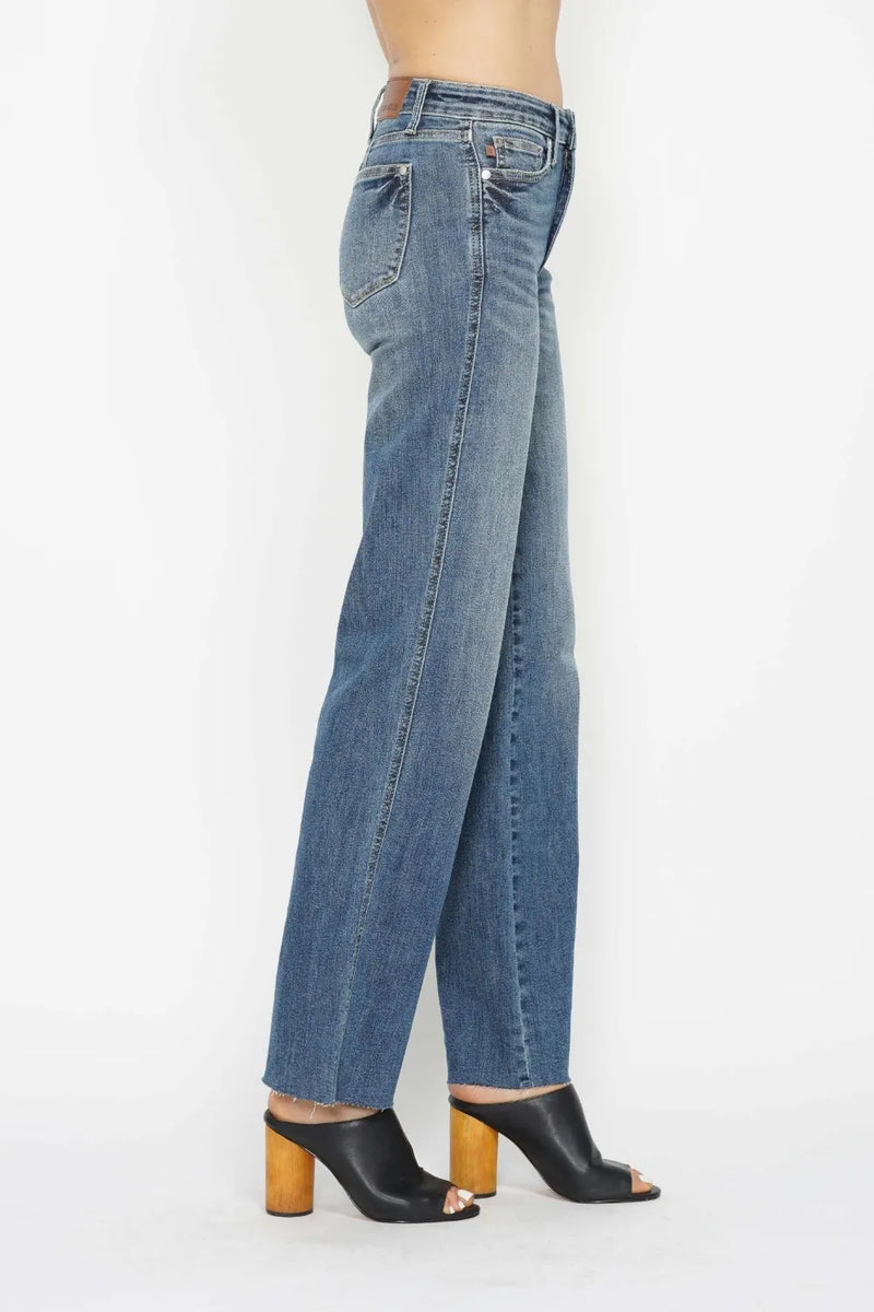 Blue jeans worn by a person on a white background