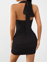 Black halter neck dress with ruched details on a white background