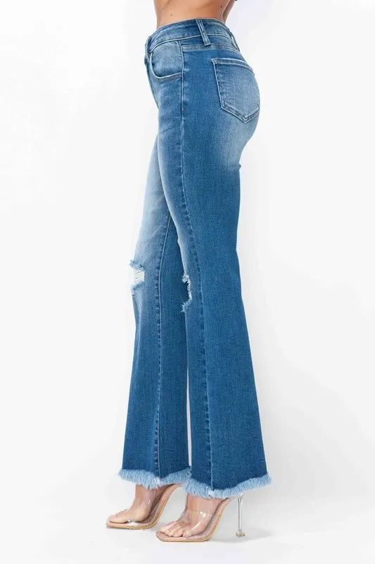 Blue jeans worn by a person on a white background