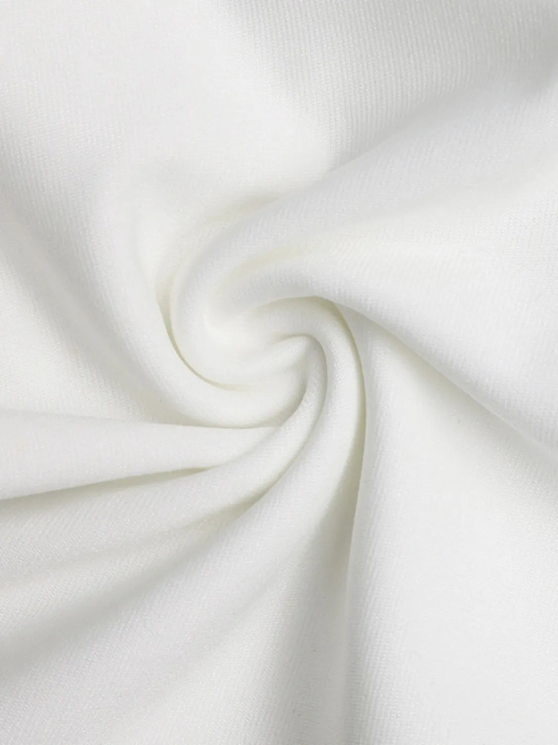 Close-up of white fabric with a subtle swirl pattern