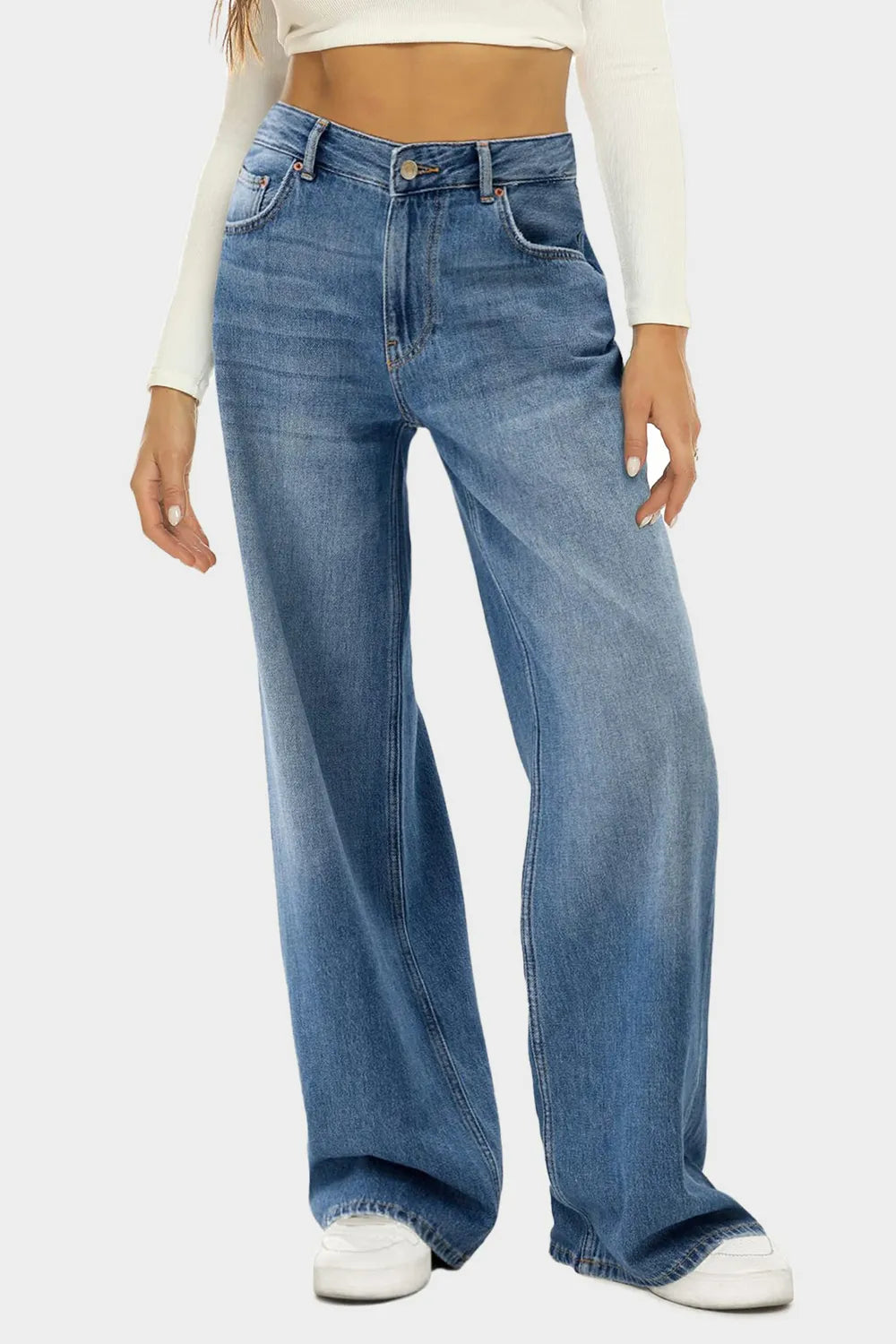 Person wearing blue jeans on a white background