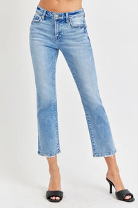 Light blue jeans worn by a person on a white background