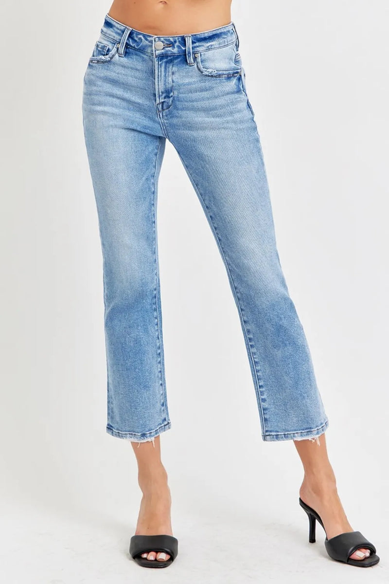 Light blue jeans worn by a person on a white background