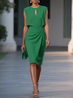 Woman wearing a green dress walking outdoors.