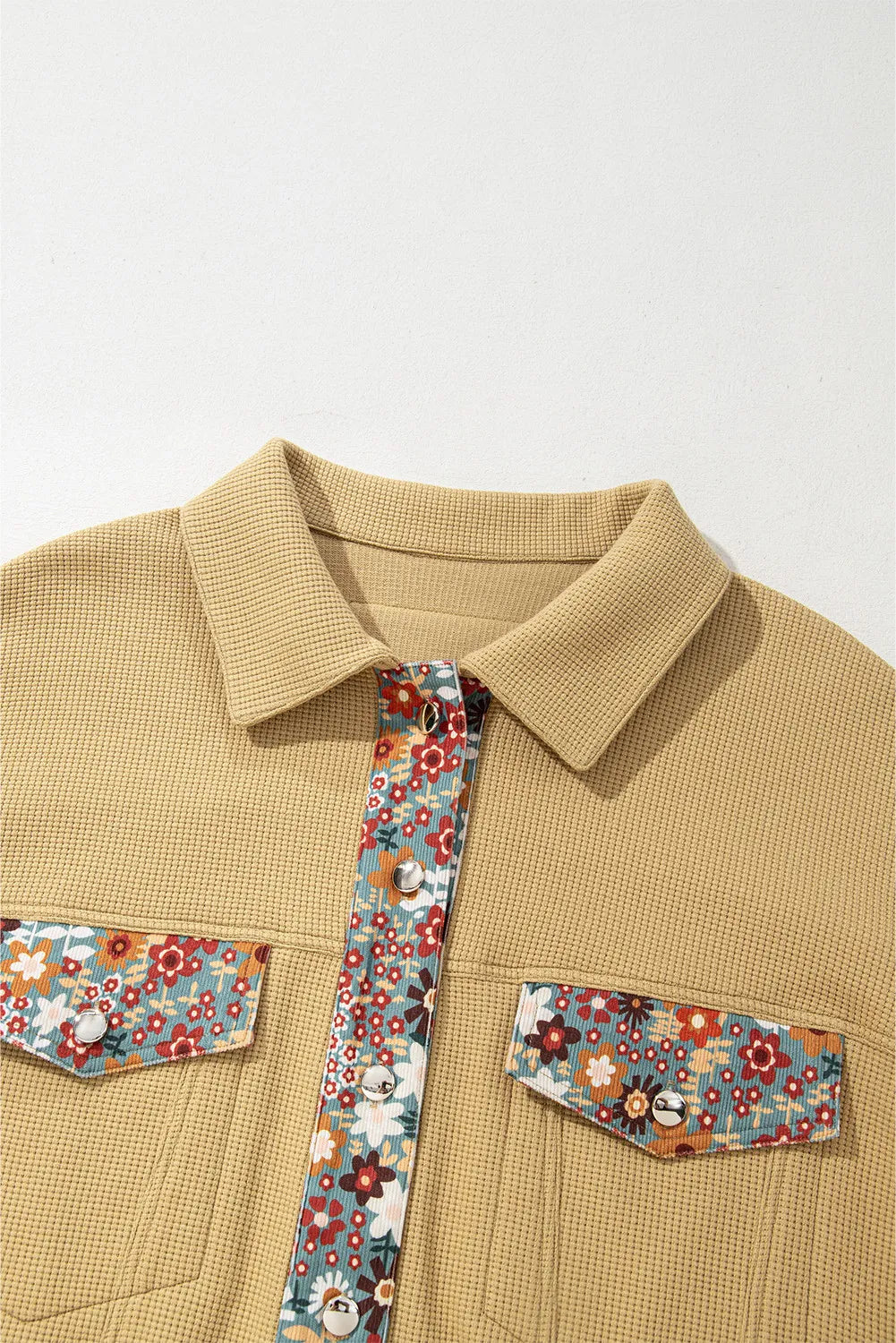 Beige shirt with floral pocket squares and tie on a white background