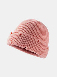 Pink knit baby hat on a white background