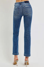 Blue jeans worn by a person on a white background