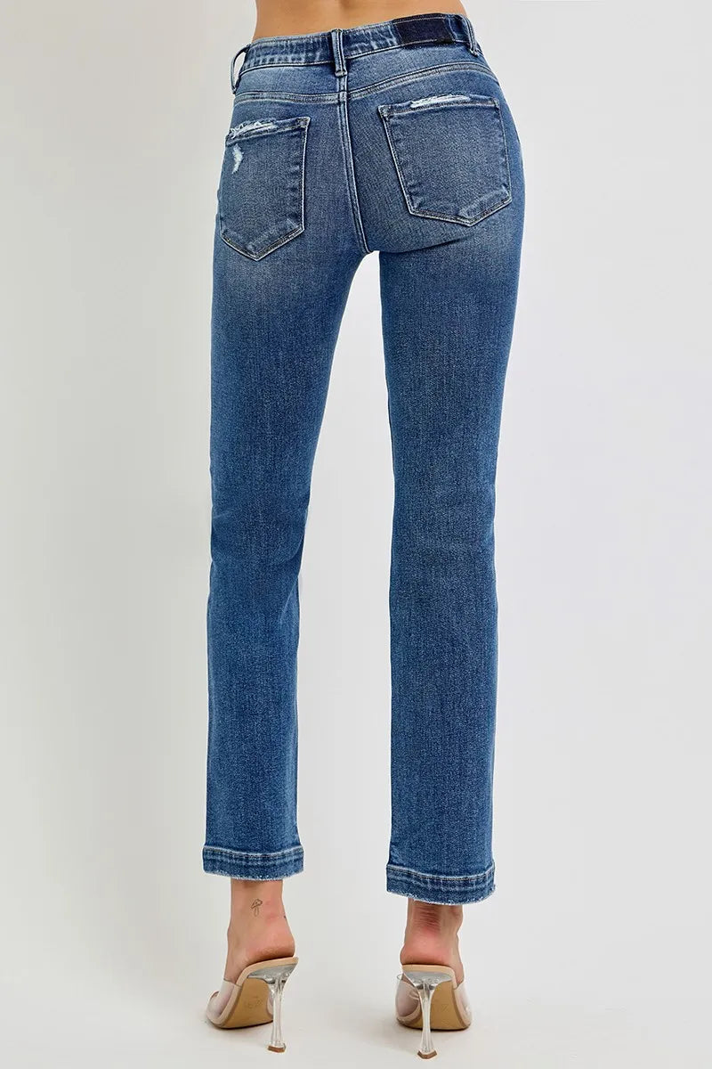 Blue jeans worn by a person on a white background