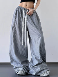 Person wearing wide-leg striped pants with a plain background