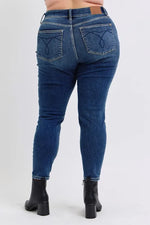 Blue jeans worn by a person on a white background