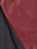 Close-up of a red leather surface with a dark gray background