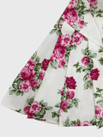 Floral fabric with pink flowers and green leaves on a white background