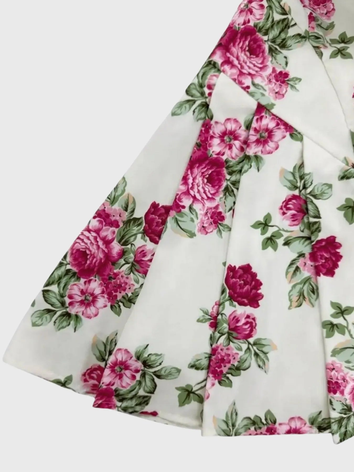 Floral fabric with pink flowers and green leaves on a white background