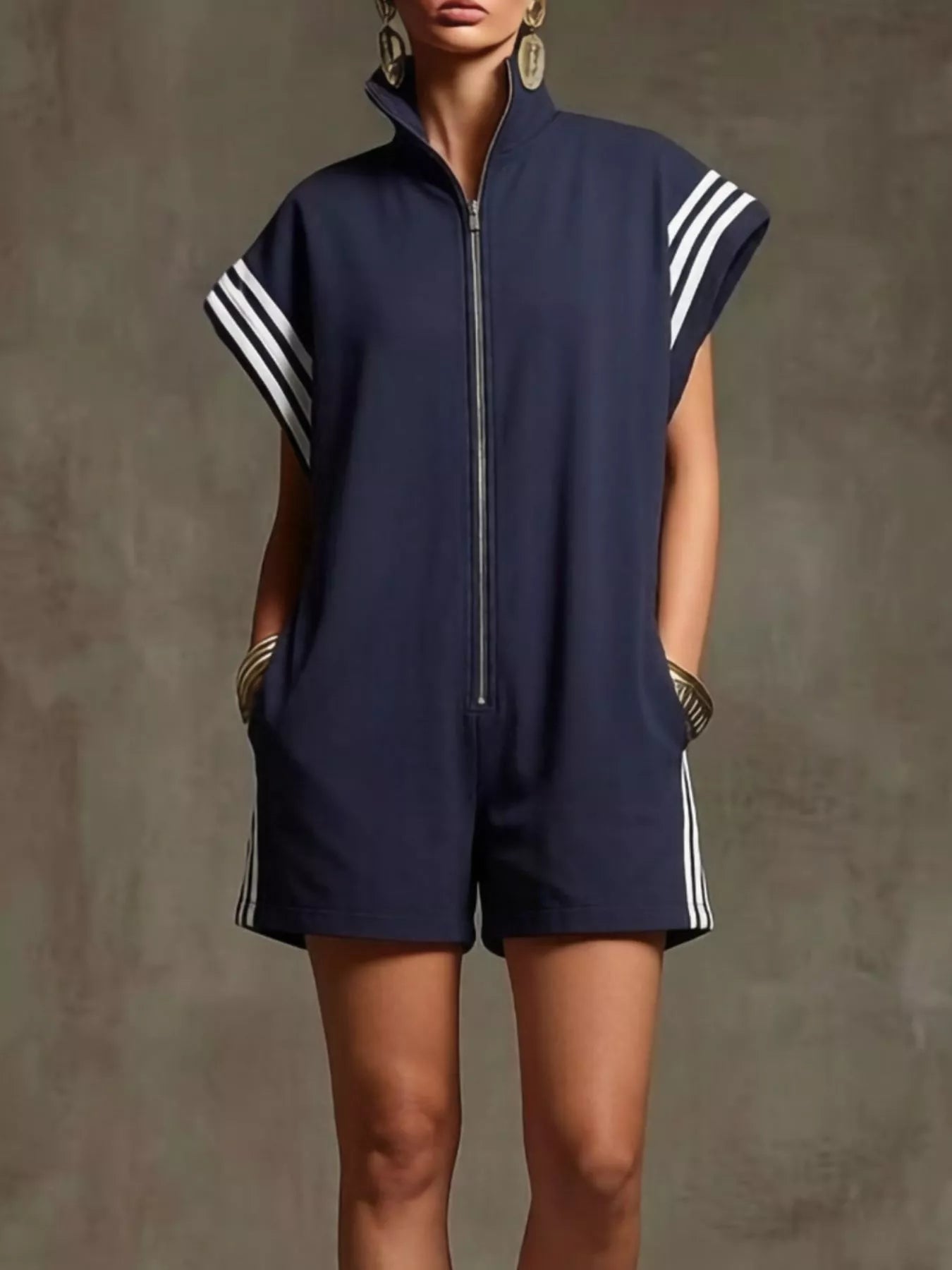 Navy blue sleeveless romper with white stripes on a plain background